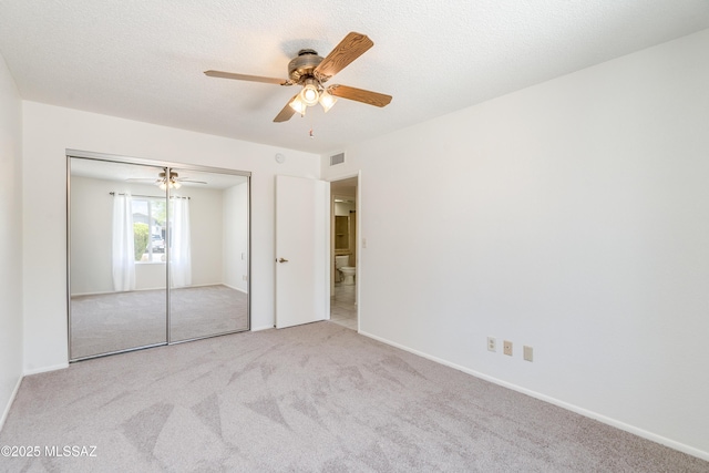 unfurnished bedroom with visible vents, baseboards, a closet, carpet, and a ceiling fan