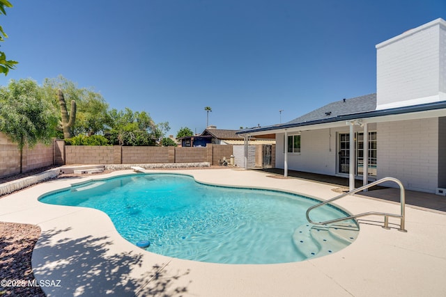 view of swimming pool featuring a fenced backyard, a fenced in pool, and a patio area