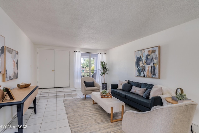 living area with light tile patterned flooring and a textured ceiling