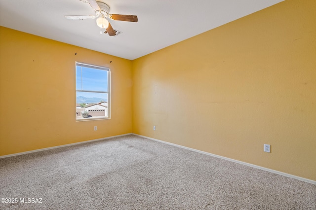 carpeted empty room with baseboards and ceiling fan