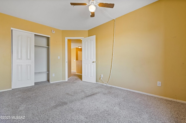 unfurnished bedroom with carpet floors, a closet, a ceiling fan, and baseboards