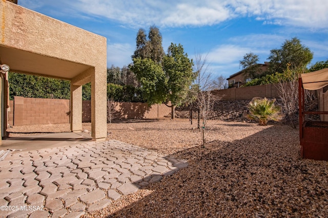 view of yard with a fenced backyard and a patio