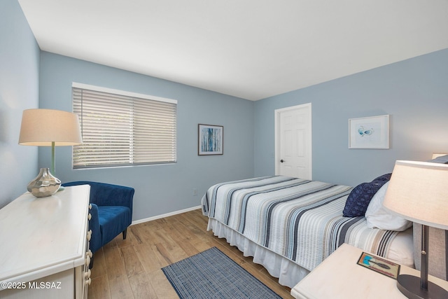 bedroom featuring baseboards and hardwood / wood-style floors