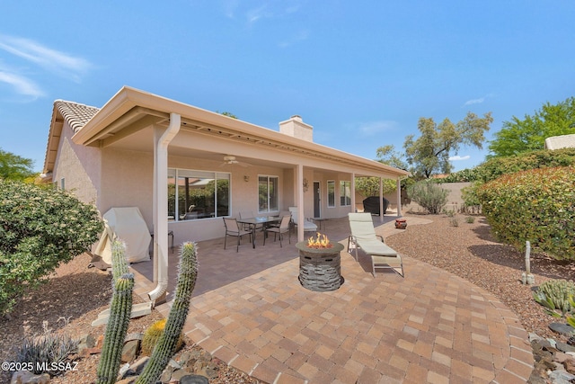 view of patio / terrace with an outdoor fire pit, a grill, ceiling fan, and a fenced backyard