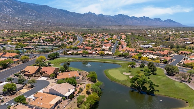 birds eye view of property with a water and mountain view, view of golf course, and a residential view