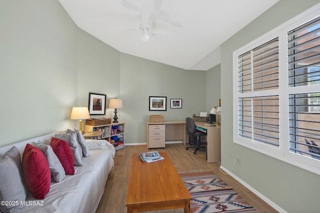 living room with high vaulted ceiling, baseboards, a ceiling fan, and wood finished floors