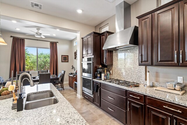 660 W Aviator Crossing Dr, Oro Valley, AZ 85755 - kitchen with ceiling fan, visible vents, appliances with stainless steel finishes, a sink, and wall chimney exhaust hood