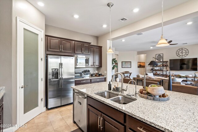 660 W Aviator Crossing Dr, Oro Valley, AZ 85755 - kitchen featuring visible vents, a sink, dark brown cabinets, and stainless steel appliances