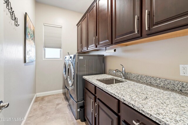 660 W Aviator Crossing Dr, Oro Valley, AZ 85755 - laundry room featuring cabinet space, independent washer and dryer, baseboards, and a sink