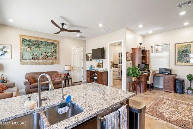 660 W Aviator Crossing Dr, Oro Valley, AZ 85755 - kitchen featuring light stone countertops, a sink, a ceiling fan, open floor plan, and visible vents
