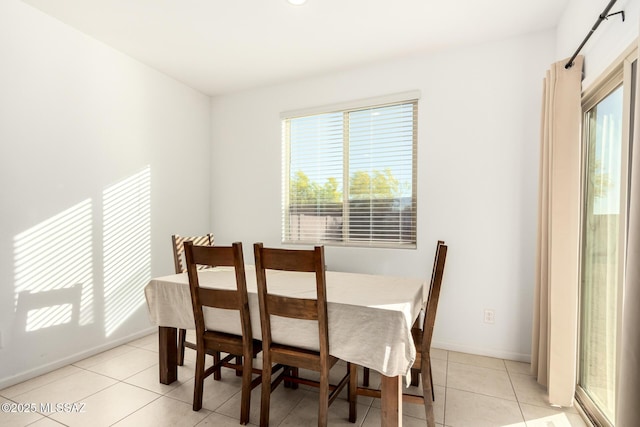 dining space with baseboards and light tile patterned floors