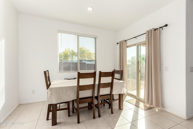 dining room featuring baseboards, recessed lighting, and light tile patterned flooring
