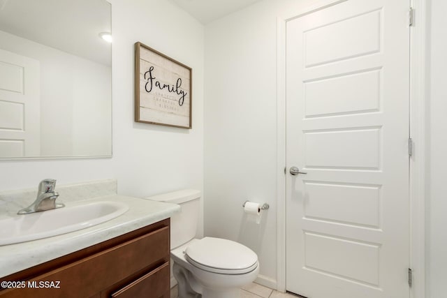 bathroom featuring toilet, vanity, and tile patterned floors