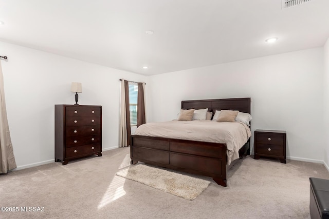 bedroom with visible vents, baseboards, and light carpet