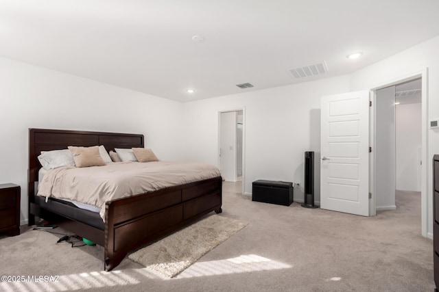 bedroom featuring light carpet, visible vents, and recessed lighting