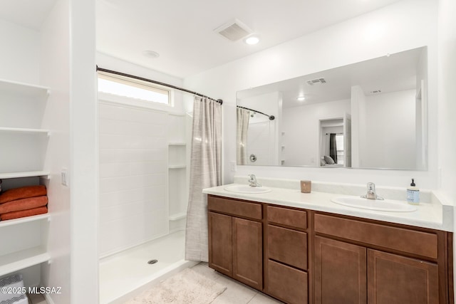 full bathroom featuring a shower stall, a sink, and visible vents