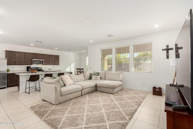 living room featuring light tile patterned floors, recessed lighting, and visible vents