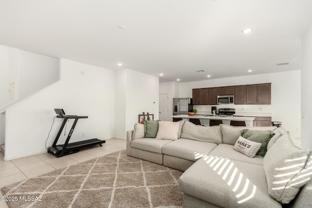 living area featuring recessed lighting, visible vents, and light tile patterned floors