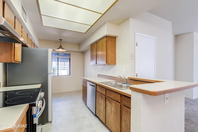 kitchen featuring range with electric cooktop, light countertops, brown cabinets, dishwasher, and a sink