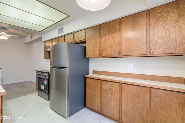 kitchen featuring stainless steel appliances, a ceiling fan, visible vents, light carpet, and light countertops