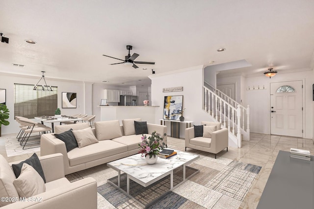 living room with ceiling fan with notable chandelier, stairway, marble finish floor, ornamental molding, and recessed lighting