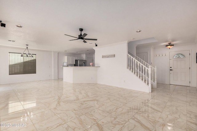 unfurnished living room featuring ceiling fan with notable chandelier, marble finish floor, visible vents, recessed lighting, and stairway