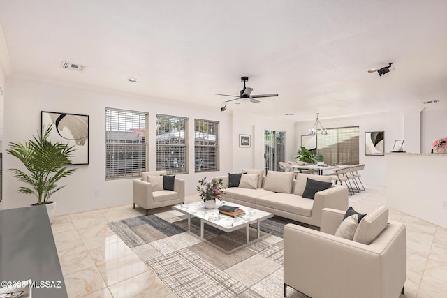 living area featuring marble finish floor, ceiling fan with notable chandelier, and visible vents