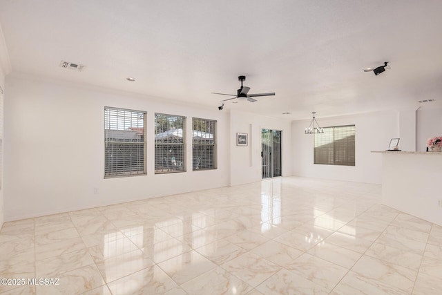 spare room featuring visible vents and ceiling fan with notable chandelier