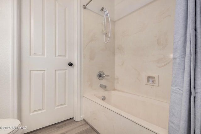 full bathroom featuring shower / bath combination, toilet, and wood finished floors