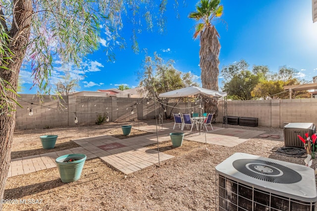 exterior space featuring central air condition unit and a fenced backyard