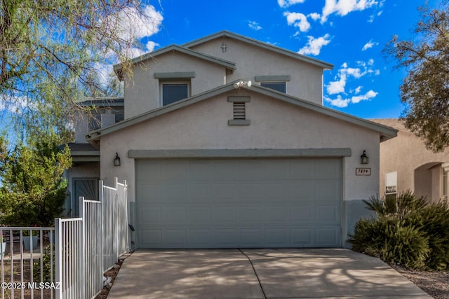 traditional-style house with a garage, stucco siding, and driveway