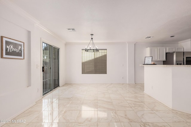 unfurnished dining area featuring ornamental molding, marble finish floor, and a notable chandelier