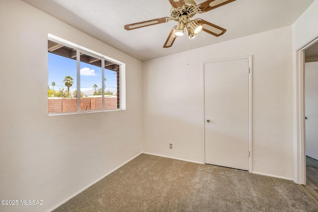 unfurnished bedroom featuring baseboards, carpet floors, and ceiling fan