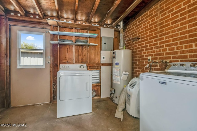 laundry area featuring water heater, washer and clothes dryer, laundry area, electric panel, and brick wall
