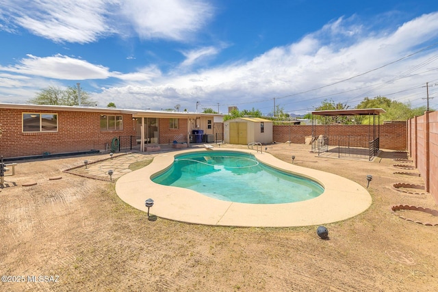 view of swimming pool with a storage shed, a fenced in pool, a fenced backyard, a patio area, and an outdoor structure