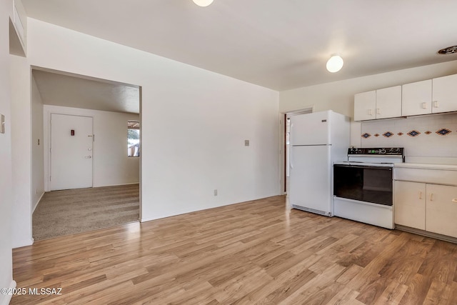 kitchen featuring white cabinets, backsplash, light countertops, white appliances, and light wood-style flooring