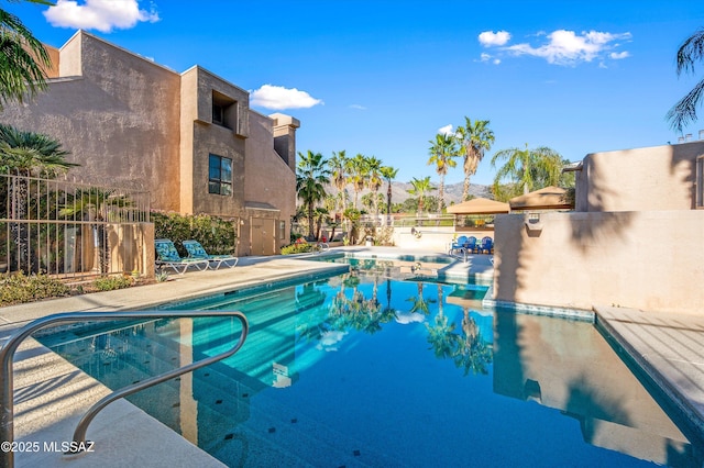 5675 N Camino Esplendora Unit 7-141, Tucson, AZ 85718 - community pool featuring fence and a patio