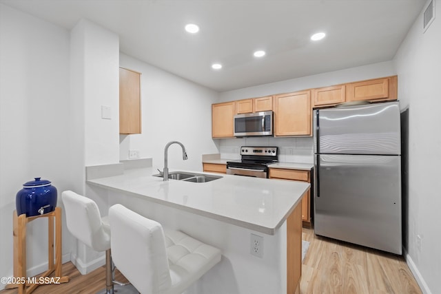 5675 N Camino Esplendora Unit 7-141, Tucson, AZ 85718 - kitchen featuring light wood finished floors, visible vents, a sink, light countertops, and appliances with stainless steel finishes