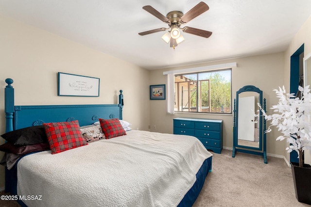 bedroom with light colored carpet, baseboards, and ceiling fan