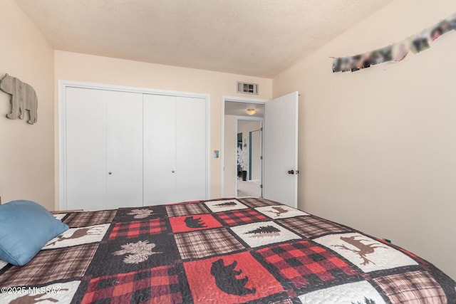 bedroom featuring visible vents and a closet