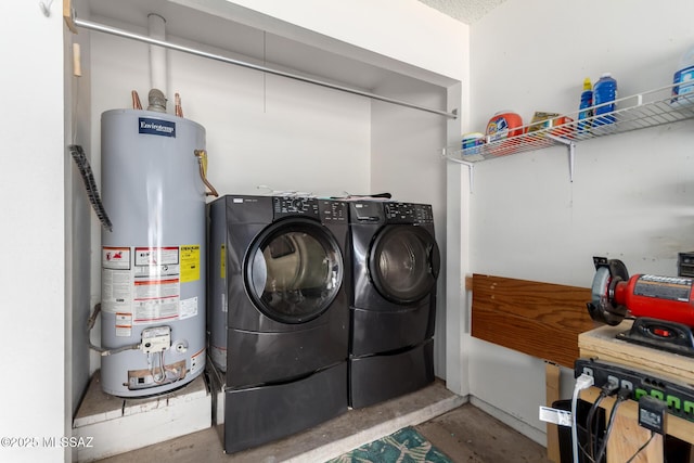 clothes washing area with laundry area, water heater, and washing machine and dryer