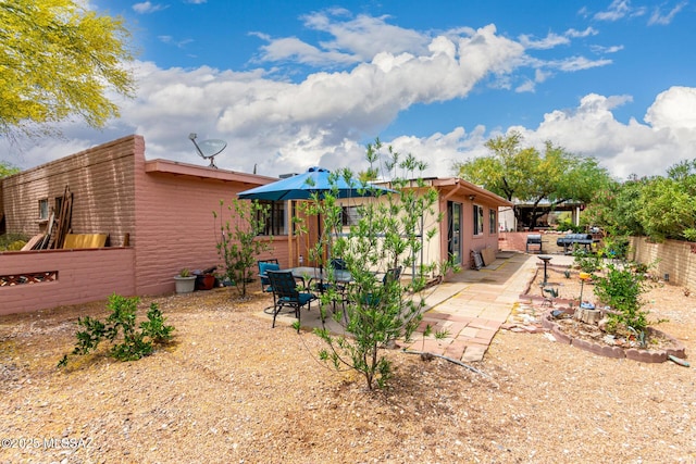 back of property with a patio and a fenced backyard