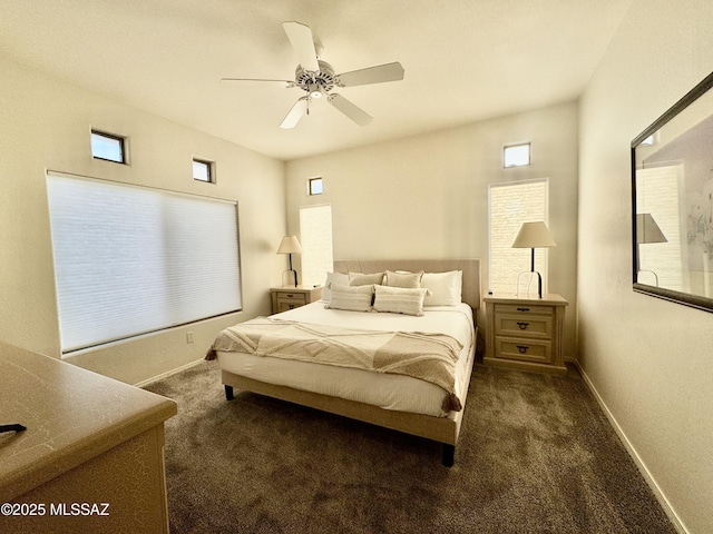 bedroom featuring dark carpet, baseboards, and a ceiling fan