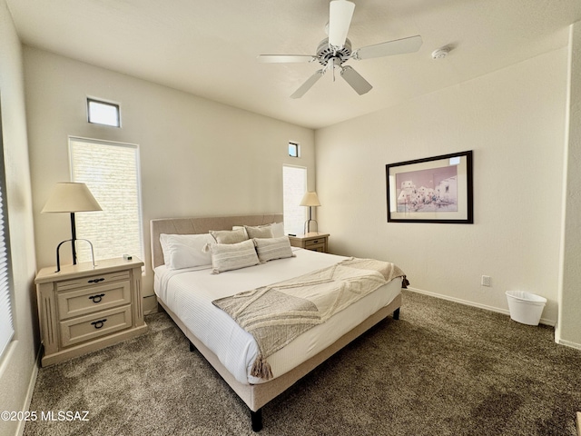 bedroom with dark carpet, ceiling fan, and baseboards