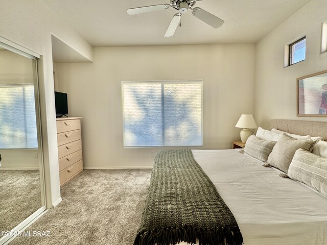 carpeted bedroom with baseboards and a ceiling fan