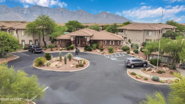 exterior space with a residential view, uncovered parking, and a mountain view