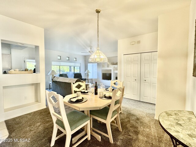 dining area featuring a ceiling fan and carpet flooring