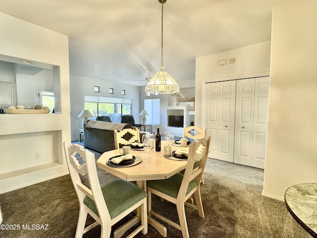 dining space featuring carpet floors and baseboards