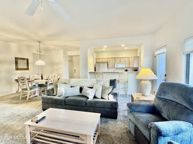 carpeted living room with a ceiling fan