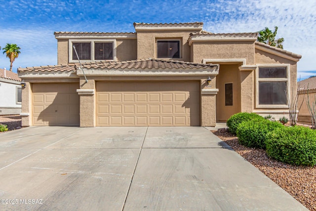 view of front facade with driveway, a tiled roof, stucco siding, and an attached garage